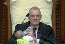 New Zealand Speaker Cradles MP's Baby During Parliament Debate Photo